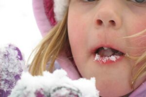 child-tasting-snowflakes
